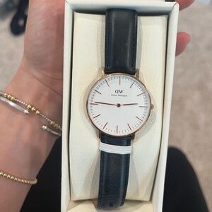 Daniel Wellington Gold watch with black leather band.